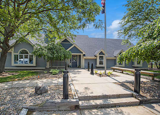 A leasing office and community building with a flag on a pole at Pine Knoll Apartments, Michigan, 49014