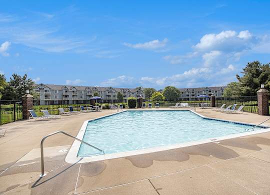 A large swimming pool surrounded by lounge chairs at Pine Knoll Apartments, Michigan, 49014
