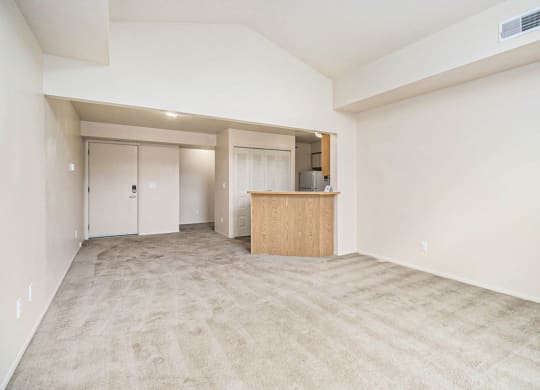 the living room with natural light from slider to balcony at Pine Knoll Apartments, Battle Creek, MI