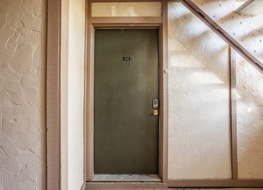 the front door of a hotel room with a green door at Polo Run Apartments, Greenwood