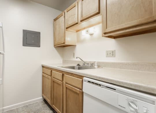 a kitchen with a dishwasher and sink and a refrigerator at Polo Run Apartments, Greenwood, IN