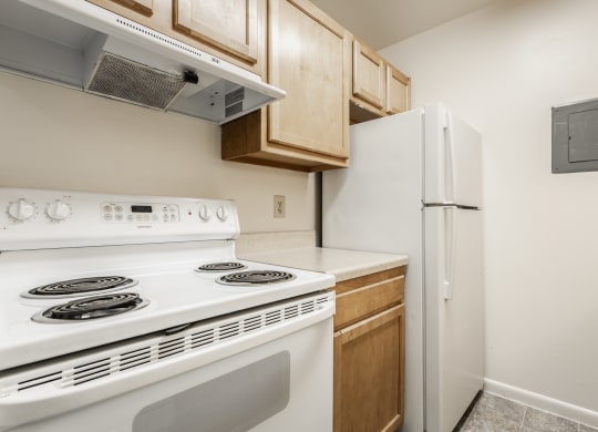 a kitchen with white appliances and a refrigerator at Polo Run Apartments, Greenwood, IN, 46142