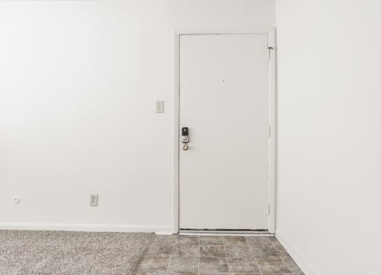 an open door in a room with white walls and a tile floor at Polo Run Apartments, Greenwood, 46142