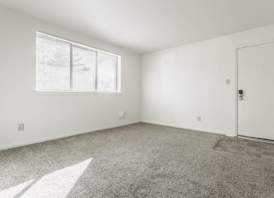 an empty living room with a door and a window at Polo Run Apartments, Greenwood, 46142