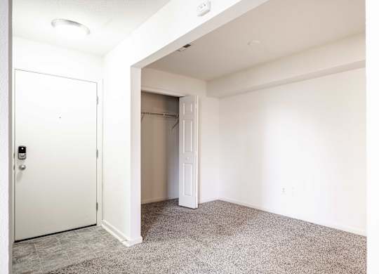 A white door is open to a carpeted room at Polo Run Apartments, Greenwood, 46142
