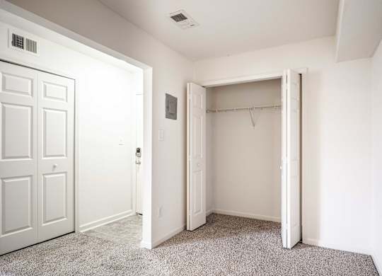 A white door is open to a room with a carpeted floor at Polo Run Apartments, Greenwood, IN, 46142