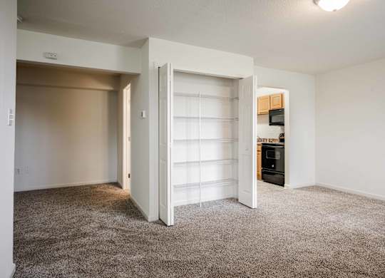 A room with a carpeted floor and a white door at Polo Run Apartments, Greenwood, Indiana, 46142