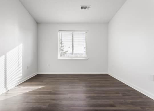 an empty bedroom with white walls and a window at Polo Run Apartments, Greenwood, IN