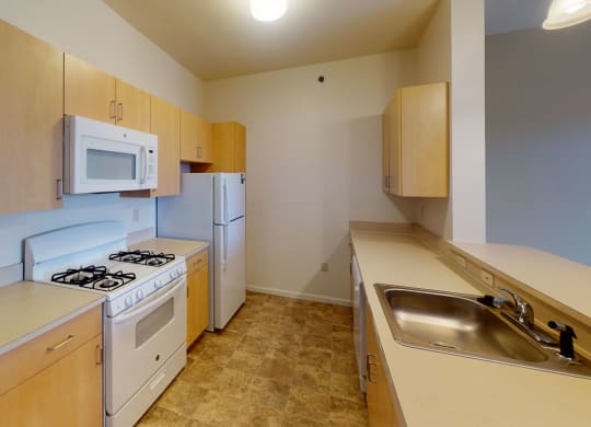 a kitchen with a gas stove, microwave and dishwasher  at Hunters Pond Apartment Homes, Champaign, IL