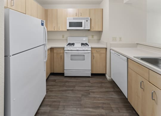 Two Bedroom Kitchen with Microwave and Gas Range at Hunters Pond Apartment Homes, Champaign, IL