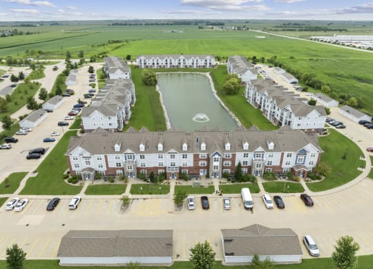 an aerial view of an apartment community with a pond at Hunters Pond Apartment Homes, Champaign, 61820