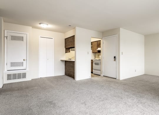 an empty living room and kitchen with white walls and carpet at Scarborough Lake Apartments, Indianapolis, Indiana, 46254