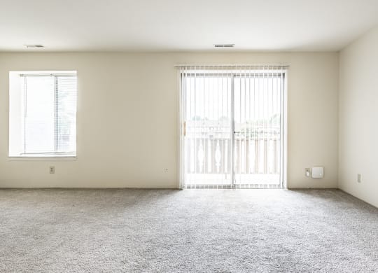 an empty living room with a window and a carpeted floor at Scarborough Lake Apartments, Indiana, 46254