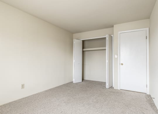 a bedroom with a closet and an open door at Scarborough Lake Apartments, Indianapolis, IN, 46254