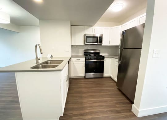 Modern Kitchen with Breakfast Bar at Green Ridge Apartments in Grand Rapids, MI