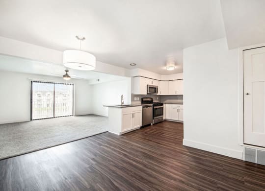 an empty kitchen and living room with a large window at Green Ridge Apartments, Grand Rapids, 49544