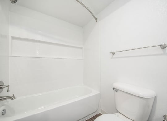 a bathroom with a toilet and a bathtub at Green Ridge Apartments, Grand Rapids, Michigan