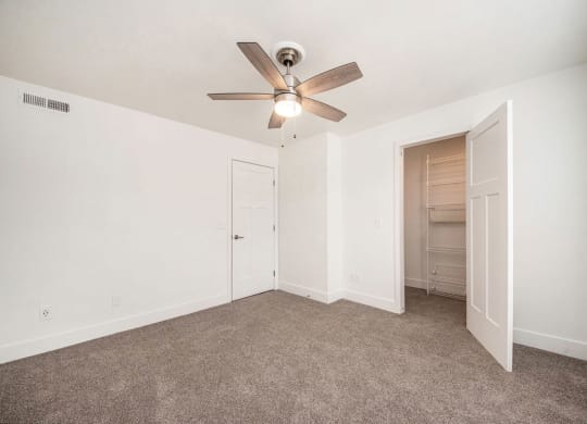 a bedroom with a ceiling fan and closet at Green Ridge Apartments, Grand Rapids