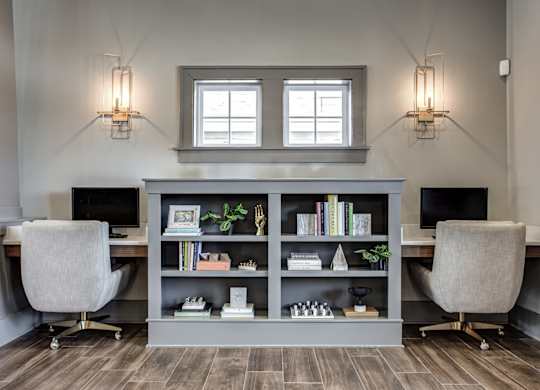 A modern home office with a desk, chair, and bookshelf. at River Crossing Apartments, St. Charles, 63303