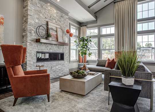 A living room with a fireplace and a chair. at River Crossing Apartments, St. Charles, 63303