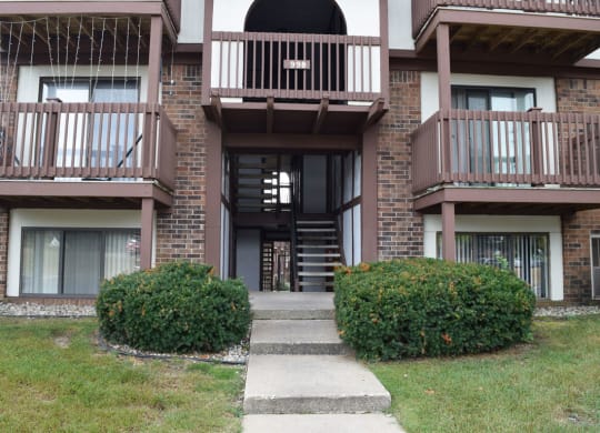 the walkway up to the entrance of a brick apartment building at Seville Apartments, Michigan