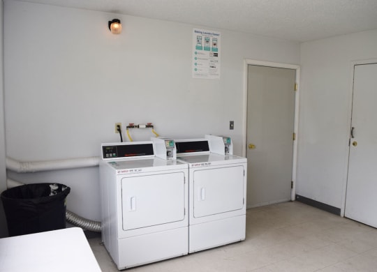 a laundry room with two washing machines at Seville Apartments, Michigan