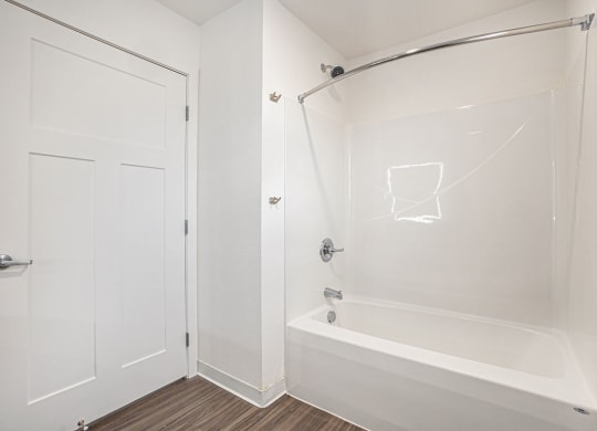 a white bathroom with a shower and a tub  at Signature Pointe Apartment Homes, Athens, Alabama