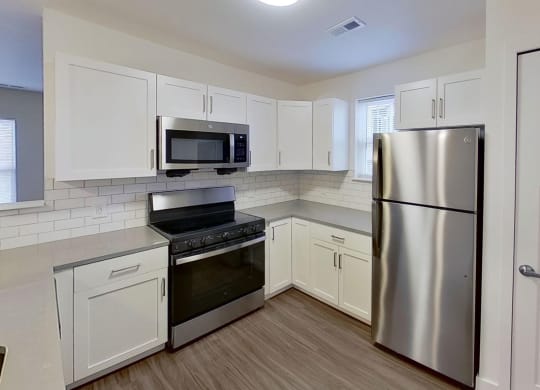 end kitchen with a window at Signature Pointe Apartment Homes in Athens, AL