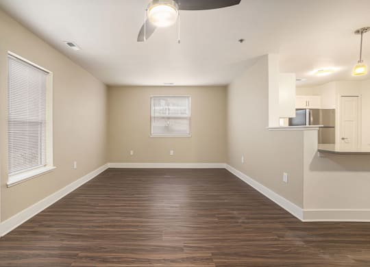 End style living room with wood flooring and an extra window  at Signature Pointe Apartment Homes, Athens, AL