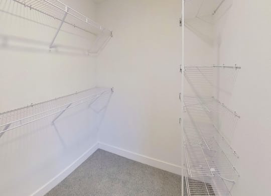 a walk in closet with wardrobe organizers at Signature Pointe Apartment Homes, Athens, AL, 35611
