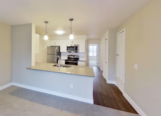 kitchen view from a living room at Signature Pointe Apartment Homes in Athens, AL