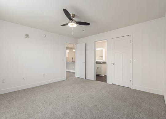 Bedroom with a ceiling fan and doors to a 2nd bathroom and closet  at Signature Pointe Apartment Homes, Athens, AL