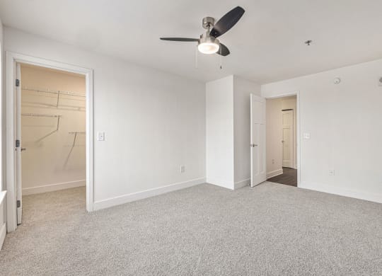 Large bedroom with a ceiling fan and a walk in closet  at Signature Pointe Apartment Homes, Alabama, 35611