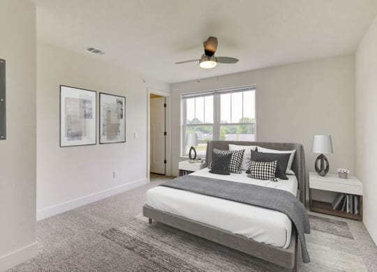 a bedroom with a large windows and a ceiling fan  at Signature Pointe Apartment Homes, Alabama, 35611