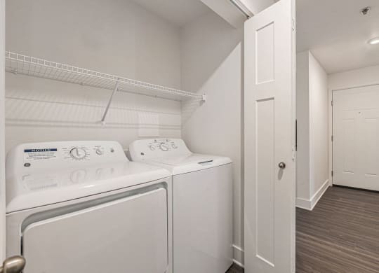 a washer and dryer in a laundry room  at Signature Pointe Apartment Homes, Athens, 35611