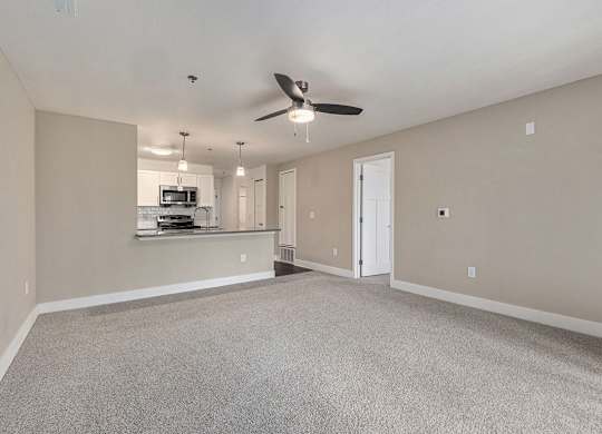 A spacious living and dining room with a ceiling fan at Signature Pointe Apartment Homes in Athens, AL