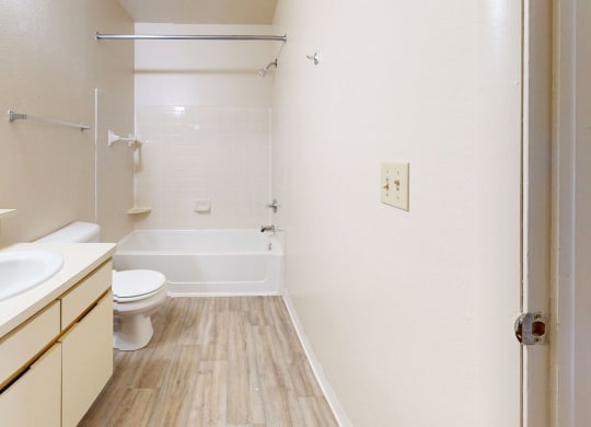 a bathroom with a sink toilet and a shower at South Bridge Apartments in Fort Wayne, Indiana