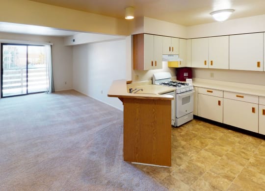 open kitchen and living room with breakfast bar at South Bridge Apartments in Fort Wayne, Indiana