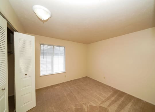 bedroom with a walk-in closet and a window at South Bridge Apartments in Fort Wayne, Indiana