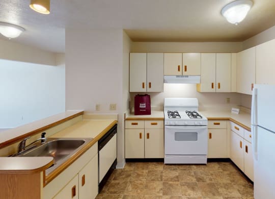 two bedroom kitchen with white appliances at South Bridge Apartments in Fort Wayne, Indiana