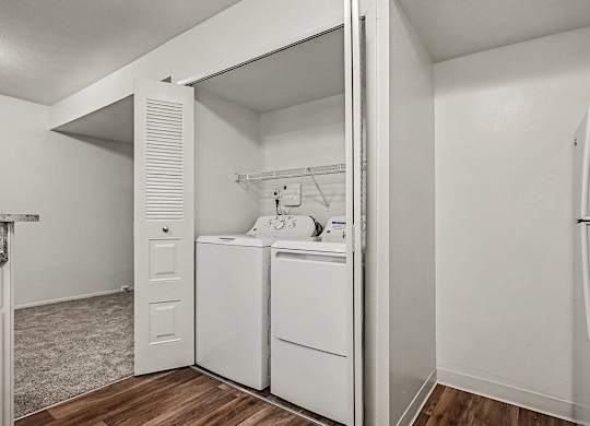 A white laundry room with a washer and dryer.