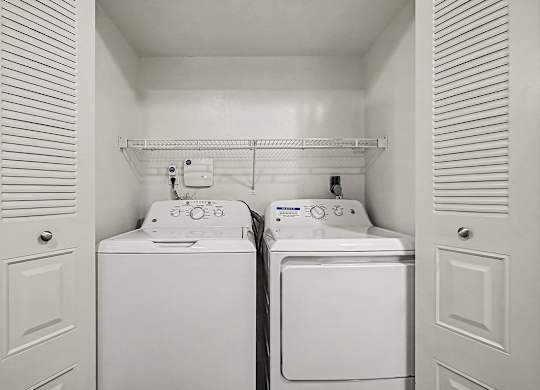 A small laundry room with a washer and dryer in it.