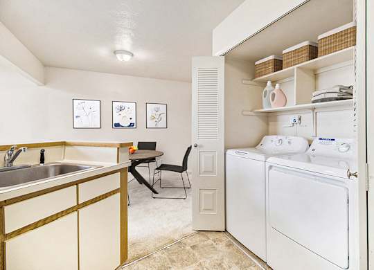 A kitchen with a washer and dryer at South Bridge Apartments in Fort Wayne, IN
