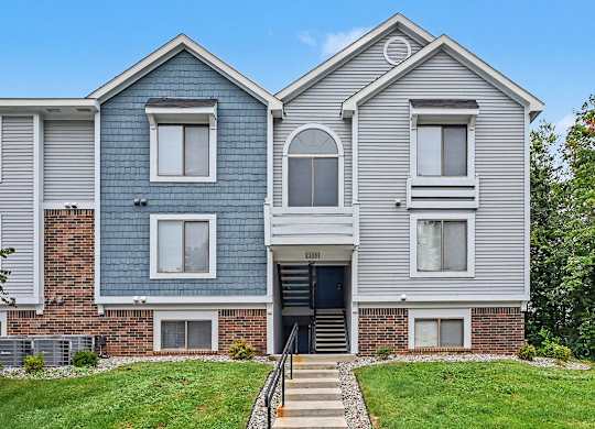 A two-story house with a blue and grey exterior.