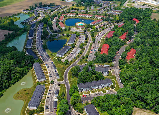 A drone view of an apartment complex with ponds at South Bridge Apartments, Fort Wayne, IN, 46816