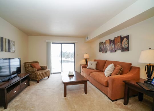Large Living Room Leads to Patio at South Bridge Apartments, Indiana