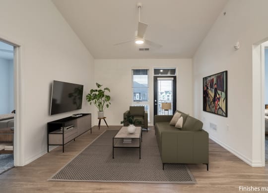 a living room with a couch and a coffee table in front of a tv  at Uptown Square Apartments, Troy