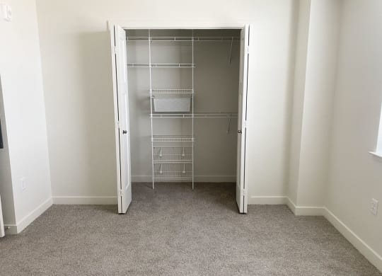 an empty walk in closet in a bedroom with carpeting at Stoney Pointe Apartment Homes, Wichita, KS
