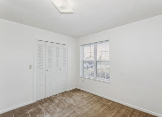 Bedroom with Large Window at Stoney Pointe Apartment Homes in Wichita, KS
