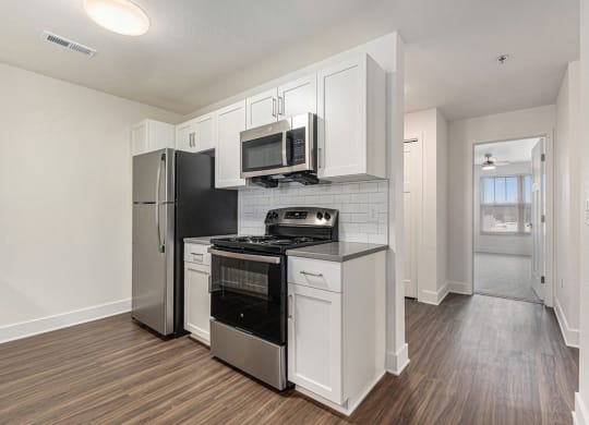 an empty kitchen with a stove and a refrigerator at Stoney Pointe Apartment Homes, Wichita, KS